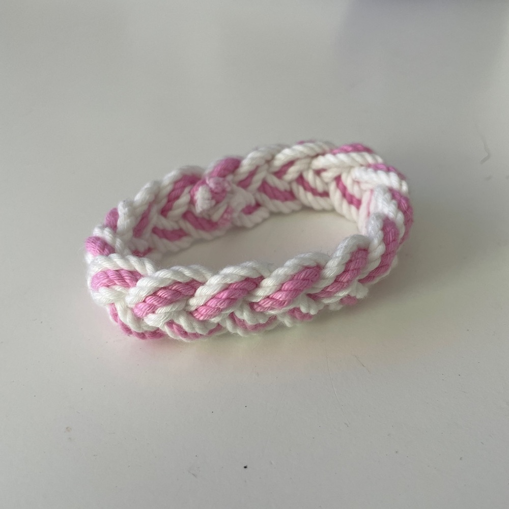 white and pink braided bracelet